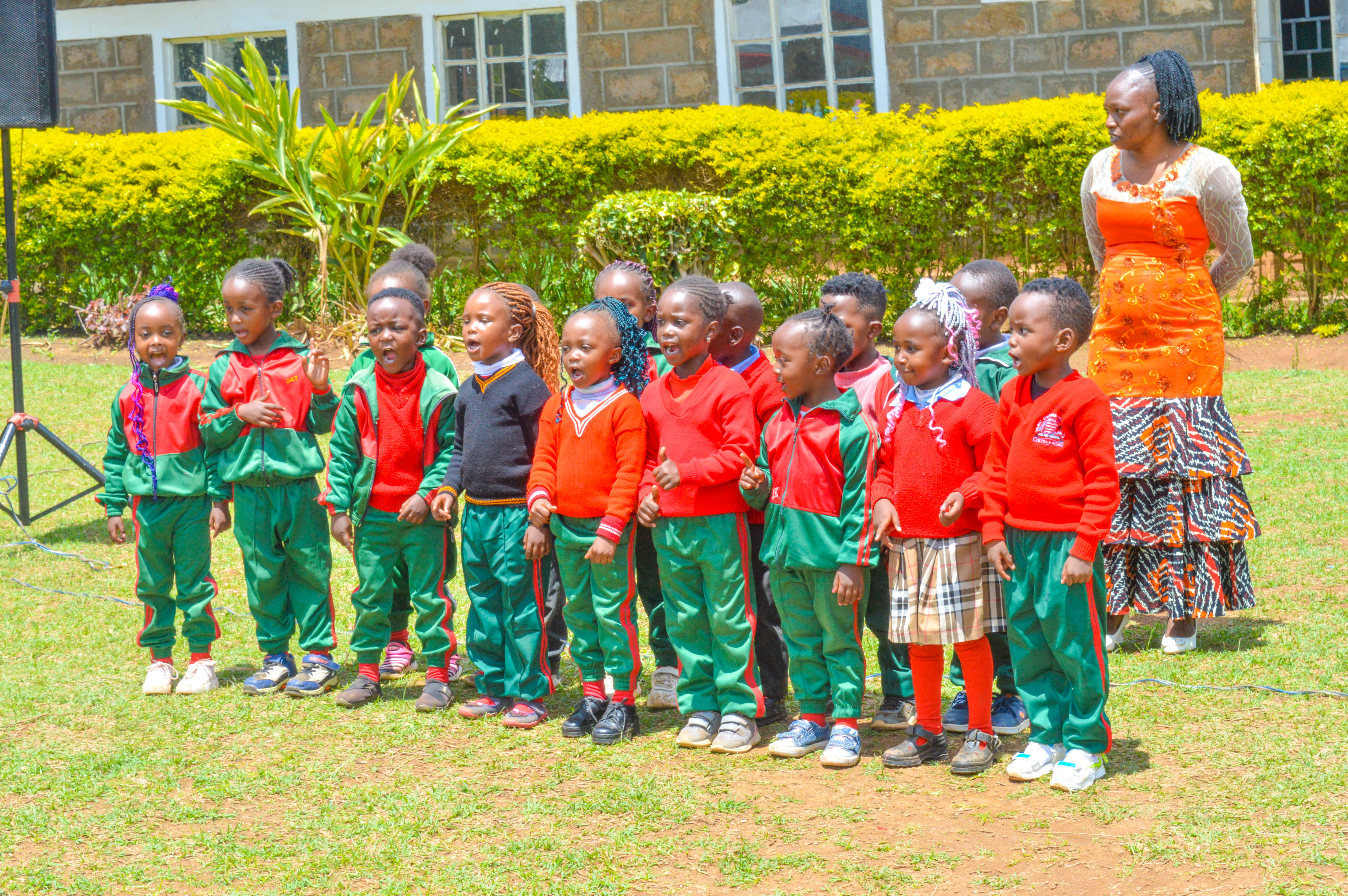 Kindergarten learners singing with teacher