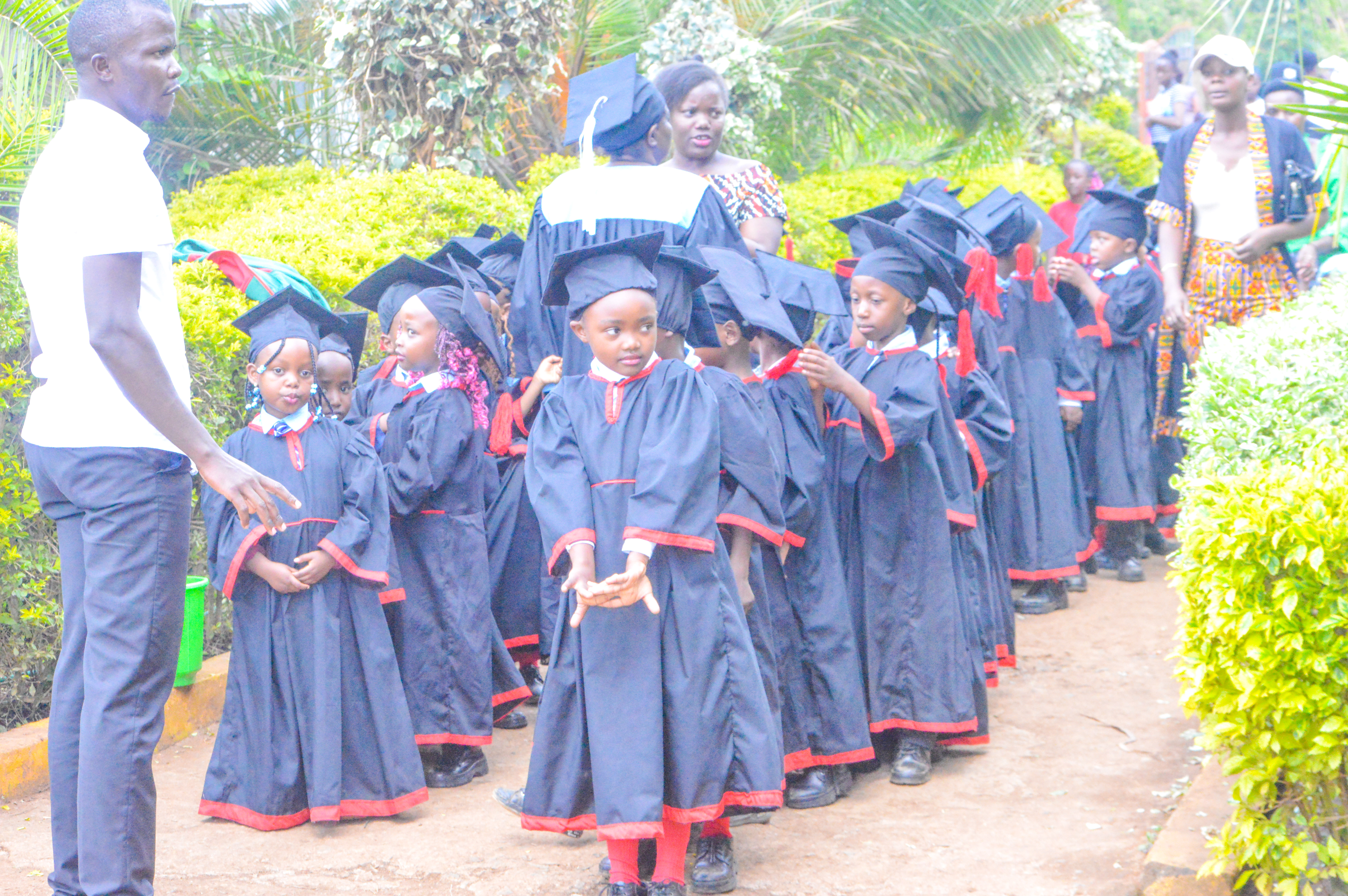 Young graduates in gowns lining up