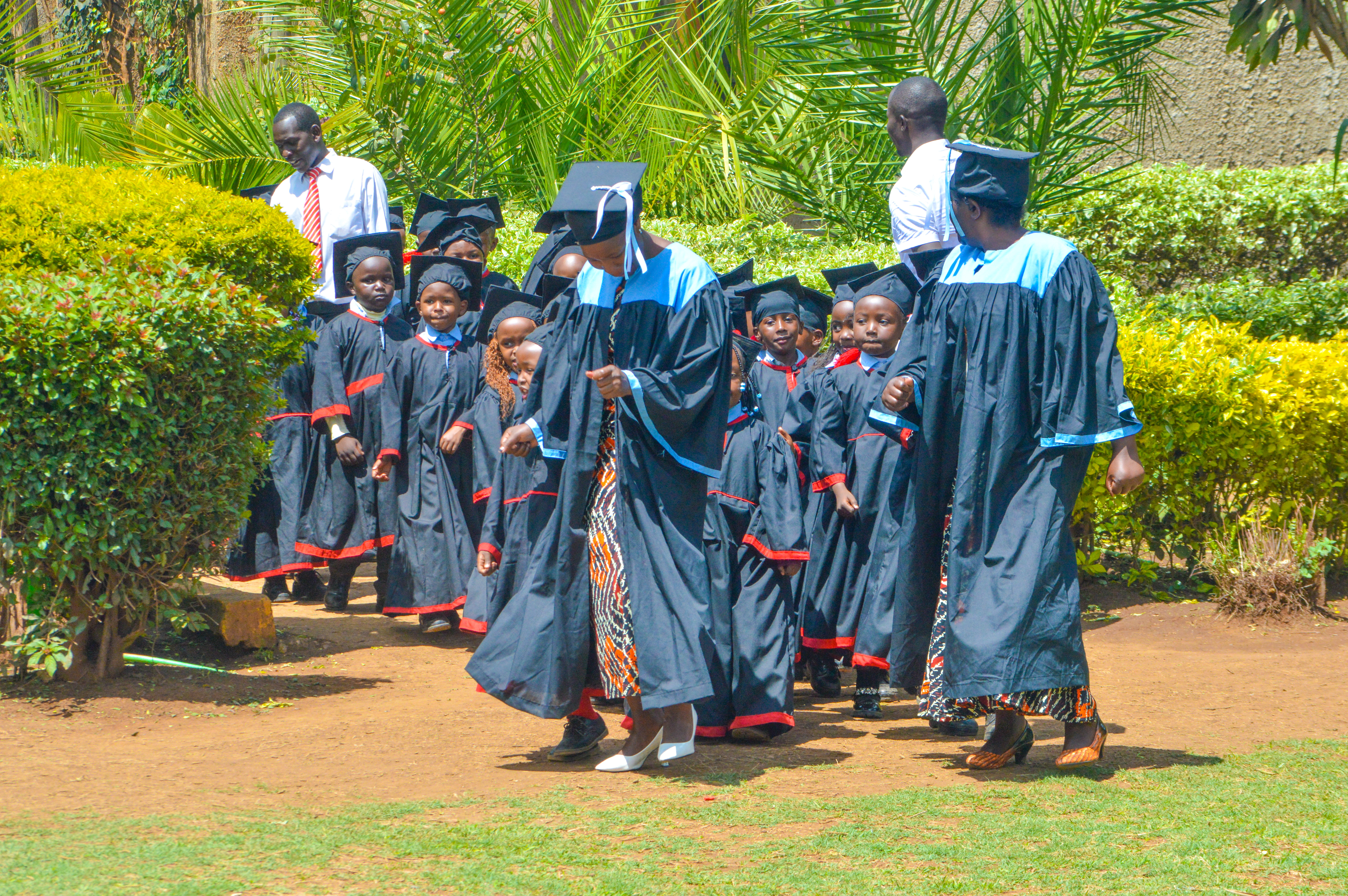 Graduates walking through campus garden