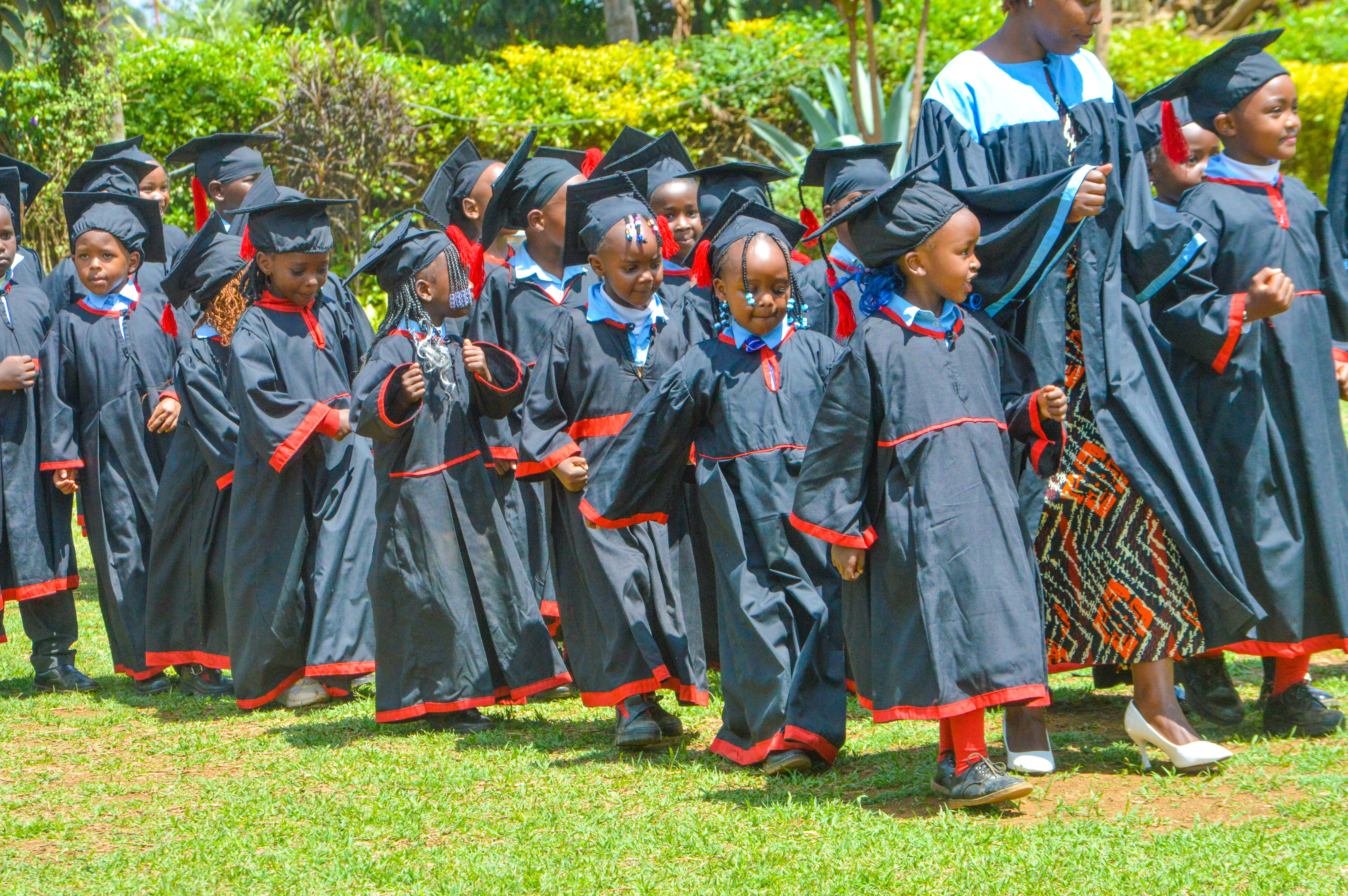 Close up of graduating learners in gowns and mortarboards